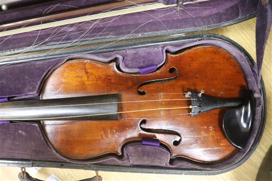 A cased violin and bows